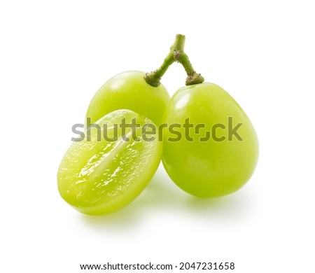 Grains of shine muscat grapes and cut shine muscat grapes on a white background. White grapes.  Japanese grapes.  Royalty-Free Stock Photo #2047231658