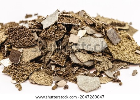 Manganese samples, flaked pure manganese metal used in industry, isolated white background. Royalty-Free Stock Photo #2047260047