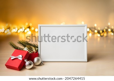 Portrait white picture frame mockup on table with boken lights and christmas decoration. High quality photo