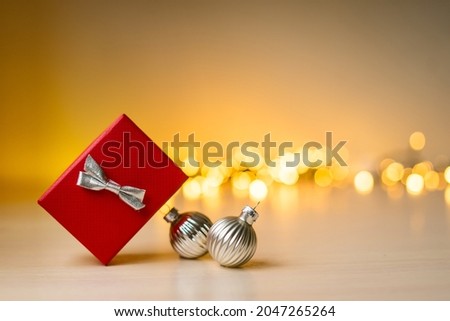 Christmas and New Year composition. Red gift box with gold gold boke lights, christmas decorations. High quality photo
