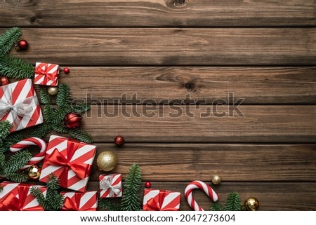 Festive Christmas background with boxes of gifts, sleigh bells and decorated fir branches
