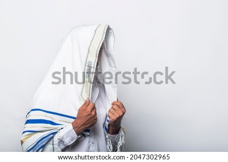 Jewish man in wrapped tallit prayer religious orthodox with prays in Jerusalem Israel. A rabbi wearing a prayer shawl in the morning. White Prayer Shawl - Tallit, jewish religious symbol. Royalty-Free Stock Photo #2047302965