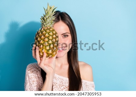 Photo of attractive pretty nice young woman hold pineapple cover half face isolated on blue color background