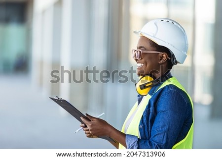 Female construction engineer. Architect with a clip board at a construction site. Young Woman look in camera, building site place background. Female builder, engineer, architect, inspector Royalty-Free Stock Photo #2047313906