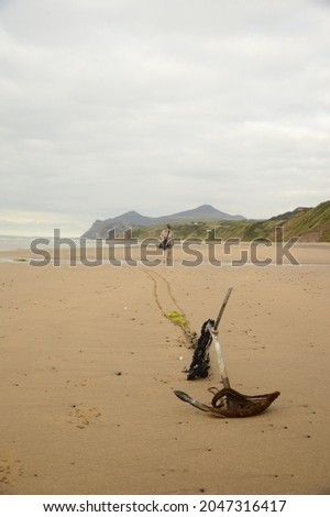 an anchor on a welsh beach in north wales.