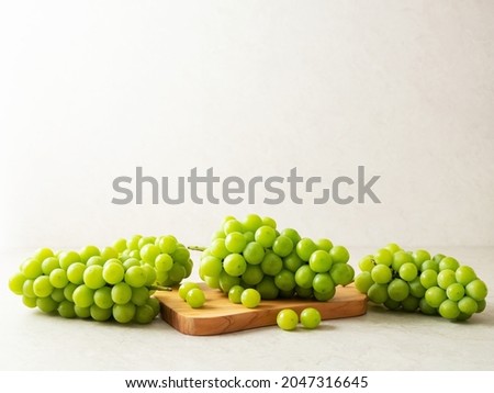 Shine Muscat, Green grapes on a cutting board  Royalty-Free Stock Photo #2047316645