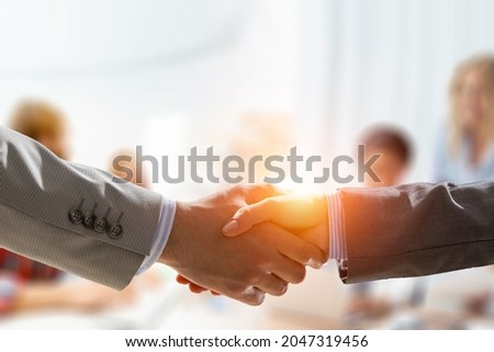 Partnership concept. Image of handshake . Mixed media