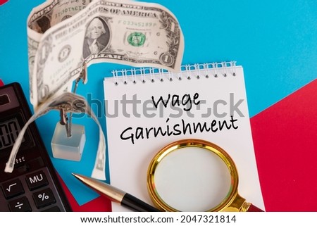Paper with Wage Garnishment on a table Royalty-Free Stock Photo #2047321814