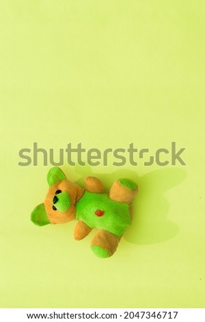 teddy doll on yellow color Vertical  background. Table top view. Flat lay. Copy space for text. 