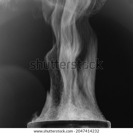 The movement of steam over the cup. Liquid evaporation. Black and white. Royalty-Free Stock Photo #2047414232
