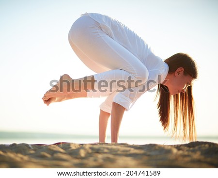 Photo of skilled female standing on palms in natural environment