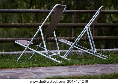 two chairs without people on a grass. High quality photo Royalty-Free Stock Photo #2047434248