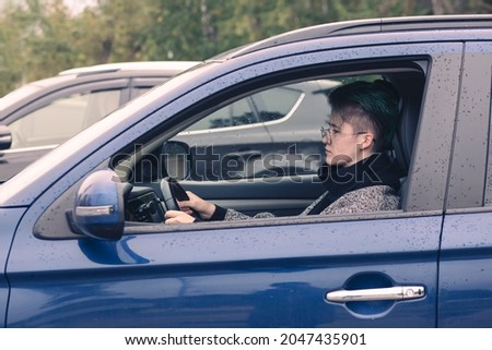 Girl driving a car. Driving training, purchase, car rental.