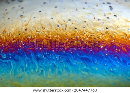 Macro picture of half soap bubble psychedelic color on black background
