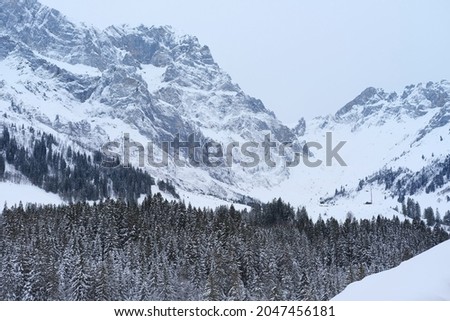 beautiful winter landscape, snow-covered trees, mountainpass, snowfall in the mountains, Swiss Alps in the snow, walks in the winter white forest, tourism, winter sports Royalty-Free Stock Photo #2047456181