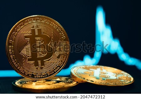 cryptocurrency close-up coin image, price chart in background