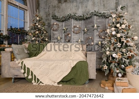 Beautiful bright location with a Christmas tree. Room decoration in New Year's style.