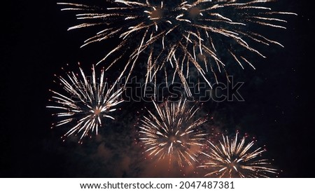 Fireworks Festival Background. Shining Real Fireworks With Bokeh Lights In The Night Sky. Glowing Fireworks Show. New Year's Eve Fireworks Celebration Holiday. Colorful Firework Flashes At Night 