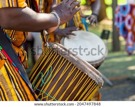 African man's hands playing the African drum. African tradition and musical culture. Royalty-Free Stock Photo #2047497848