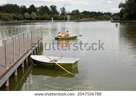 Boat at the pier. Marina with water transport. Boat station on the city lake.
