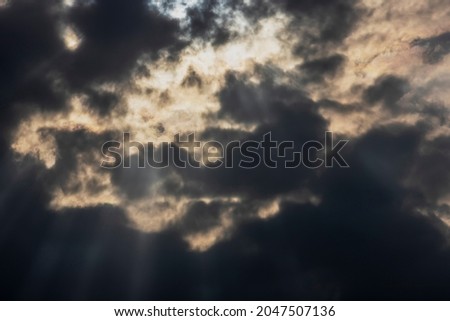 Dramatic stormy sky with sun rays. Background for winter photography, hallowen and fear. Horizontal photo and selective focus