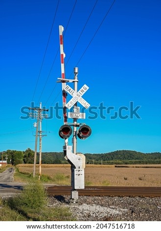 Rail road crossing sign in the farmland USA. Keeps you from crossing when a train is coming.