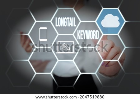 Text sign showing Longtail Keyword. Business approach search phrases that are highly relevant to specific niche Lady Holding Tablet Pressing On Virtual Button Showing Futuristic Tech.