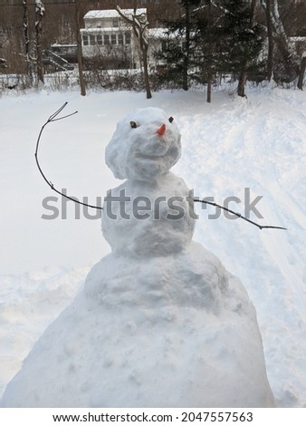 cute happy dancing snowman in backyard with sledding tracks behind, winter fun
