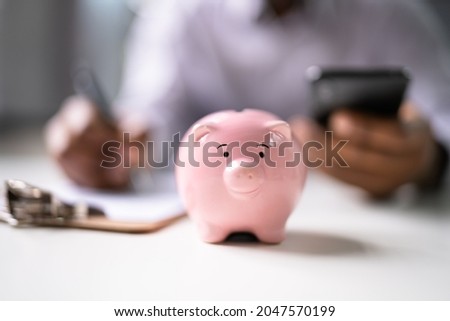 Financial Money Advice. Saving in 401K. Piggybank Deposit Royalty-Free Stock Photo #2047570199
