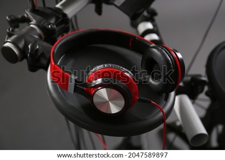 Modern electronic drum kit with headphones on grey background, closeup. Musical instrument