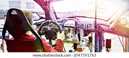 Gamer playing on computer simulator race car Royalty-Free Stock Photo #2047591763