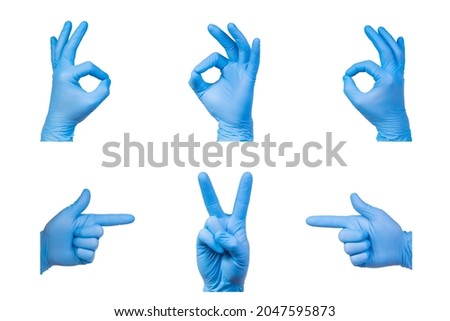 Ok and V signs are showed by man hand in a blue medical glove on a white background. Okay. The symbol of Victory. Victory over a virus.