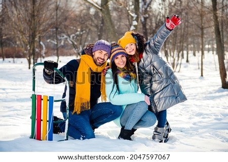 Full size photo of happy excited good mood family enjoying winter vacation father mother and daughter outside in park