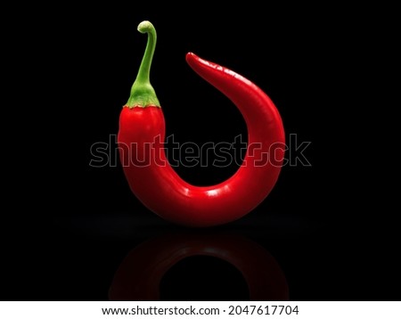 round curved red chili pepper isolated on black background Royalty-Free Stock Photo #2047617704