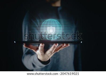Man holding tablet with padlock shield protects security icon on the virtual display.  Cyber security safe data protection business technology privacy concept. Information security system.
