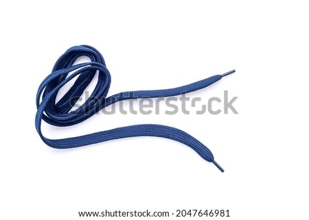 Dark-blue, blue shoelaces isolated on white, crumpled laces, top view Royalty-Free Stock Photo #2047646981