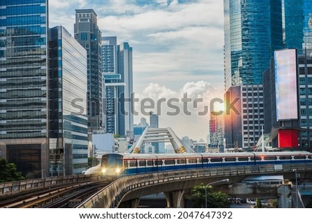 BTS Skytrain, Electric train, running on the way with business office buildings on the background. Royalty-Free Stock Photo #2047647392