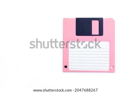 Pink floppy disk on white background