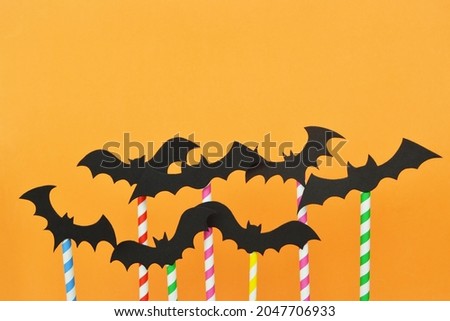 Halloween bats. Orange color background. Colorful and fun composition with space for your text. Halloween card concept.
