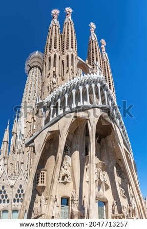 Facade of unfinished sacred family "La Sagrada Familia" , cathedral designed by Gaudi, being built since 19 March 1882 with people donations. The text "Sanctus" in the facade means saint Royalty-Free Stock Photo #2047713257