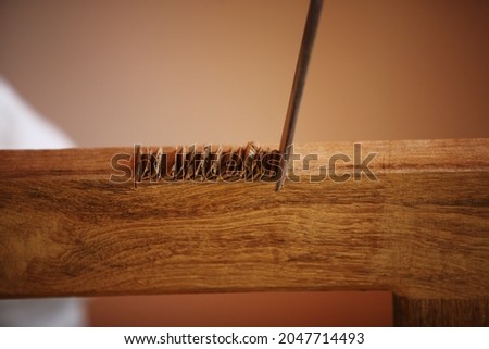 Royalty free photo of carpenter Making Hinge Recesses (Mortises) in Wooden Window Frame with chisel

