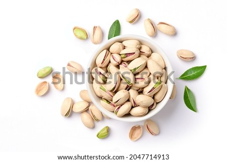 Flat lay of pistachio nuts in white bowl isolated on a white background. Royalty-Free Stock Photo #2047714913