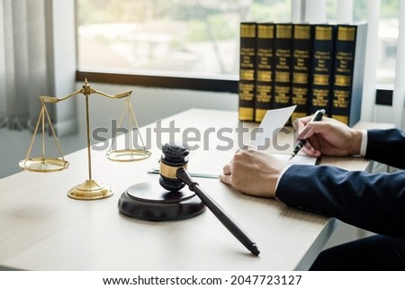 Professional man lawyers work at a law office There are scales, Scales of justice, judges gavel, and litigation documents. Concepts of law and justice.