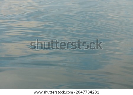 Texture of glitter water and soft waves. sparkling in water - background. sea water with sun glare and ripple. Powerful and peaceful nature concept.