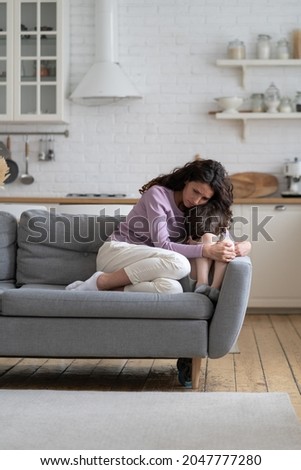Caring mom embracing offended little kid crying after abuse in family. Worried young woman hugging stressed preschool boy hiding face in hands sit on couch at home. Parent and child misunderstanding