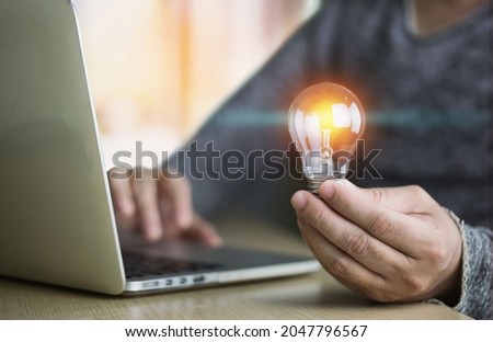 light bulb in hand have great creativity feel motivated and motivated to work business success concept Royalty-Free Stock Photo #2047796567