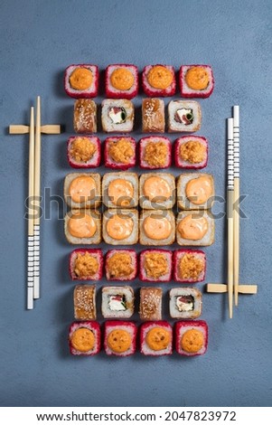 Sushi set on a gray background. Flat layout, top view. Sushi sticks.