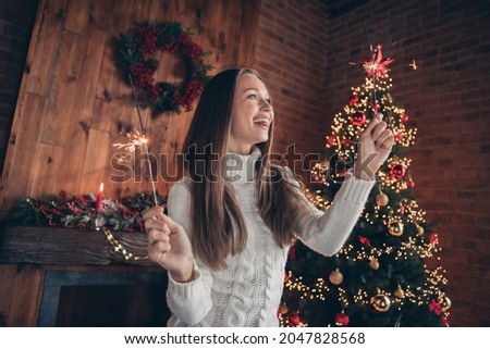 Photo of adorable cute young woman dressed knitted sweater fireworks stick smiling indoors room home house