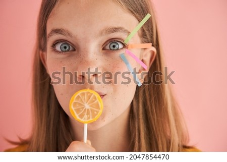European little girl closed mouth with lollipop