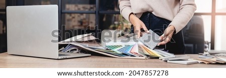 Banner interior design decorator sets ceramic tiles for walls, upholstery fabric for furniture, paint colors. Royalty-Free Stock Photo #2047857278